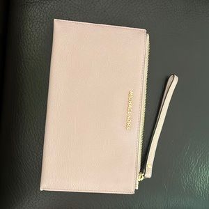 Michael Kors Leather Clutch. Color is pale pink and has never been used.